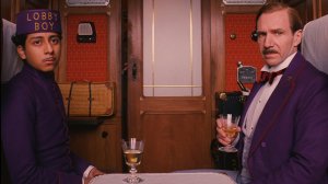 A hotel owner and his lobby boy (played by Tony Revoloro and Ralph Fiennes) go on a bizarre adventure in The Grand Budapest Hotel.